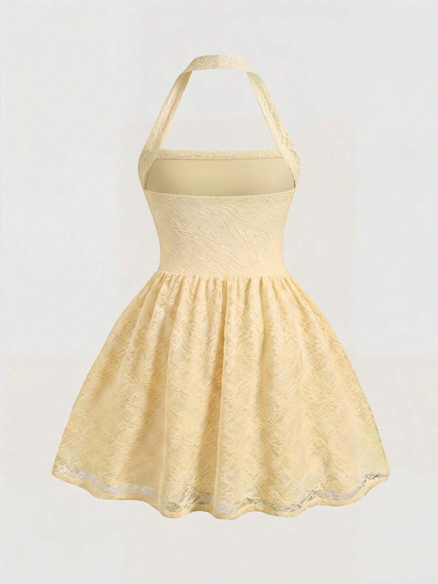 Tween girl wearing a black and white polka dot tiered cami dress with shoulder straps, a high waist, and a ruffle layered hem.