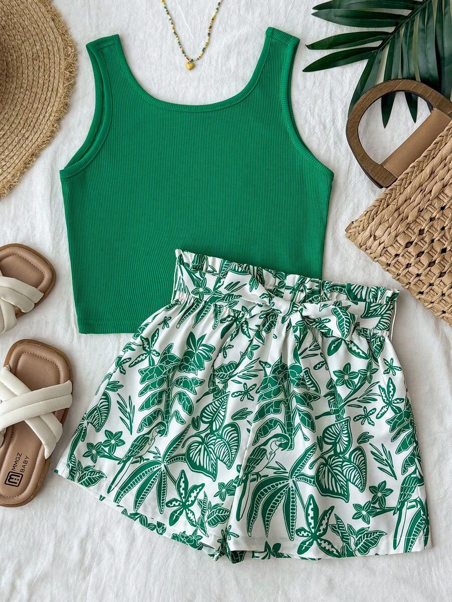 Tween girl summer two-piece outfit featuring a white scoop neck tank top and green ditsy floral print paperbag waist shorts with belt.