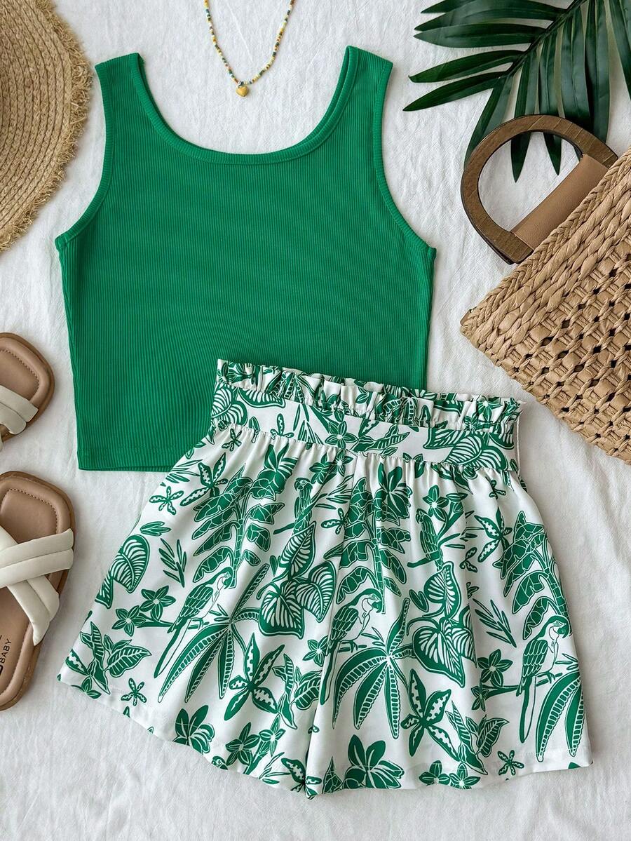 Tween girl summer two-piece outfit featuring a white scoop neck tank top and green ditsy floral print paperbag waist shorts with belt.