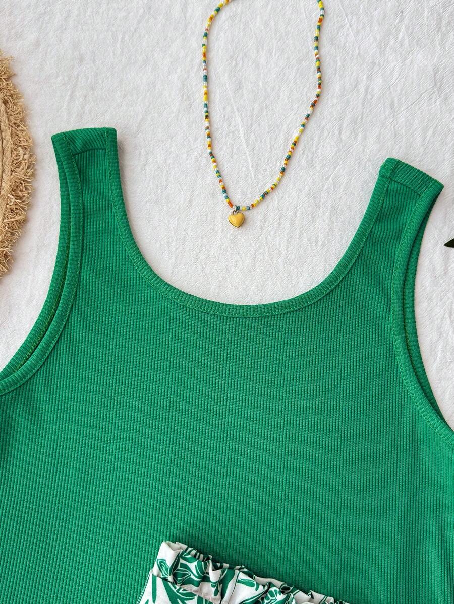 Tween girl summer two-piece outfit featuring a white scoop neck tank top and green ditsy floral print paperbag waist shorts with belt.