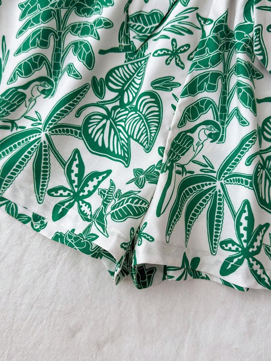 Tween girl summer two-piece outfit featuring a white scoop neck tank top and green ditsy floral print paperbag waist shorts with belt.