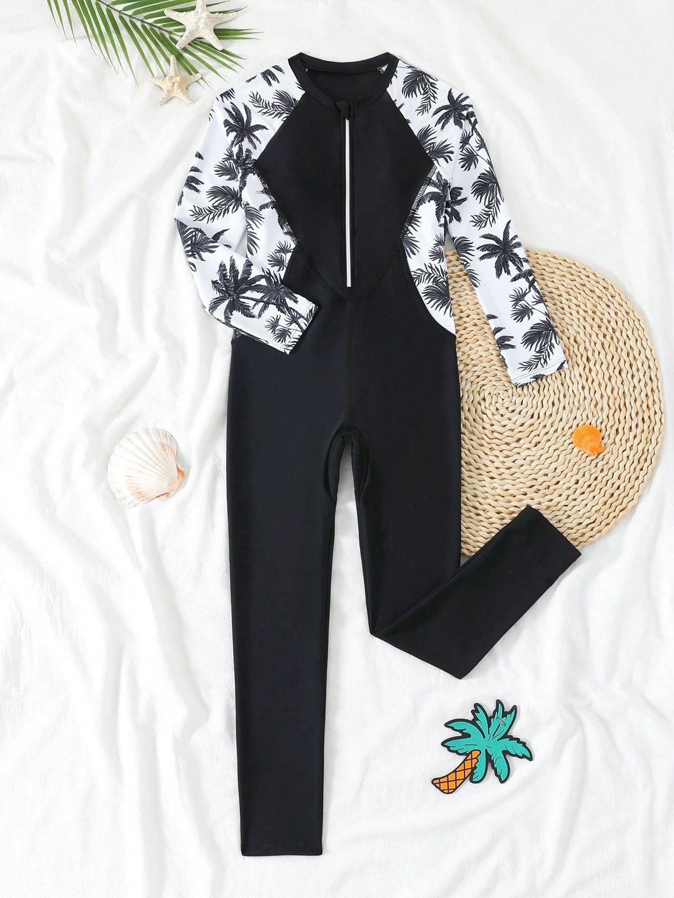 Tween girls black one-piece swimsuit with long sleeves, high neck, zipper detail, graphic leopard heart print, and fitted full-coverage swimwear style.