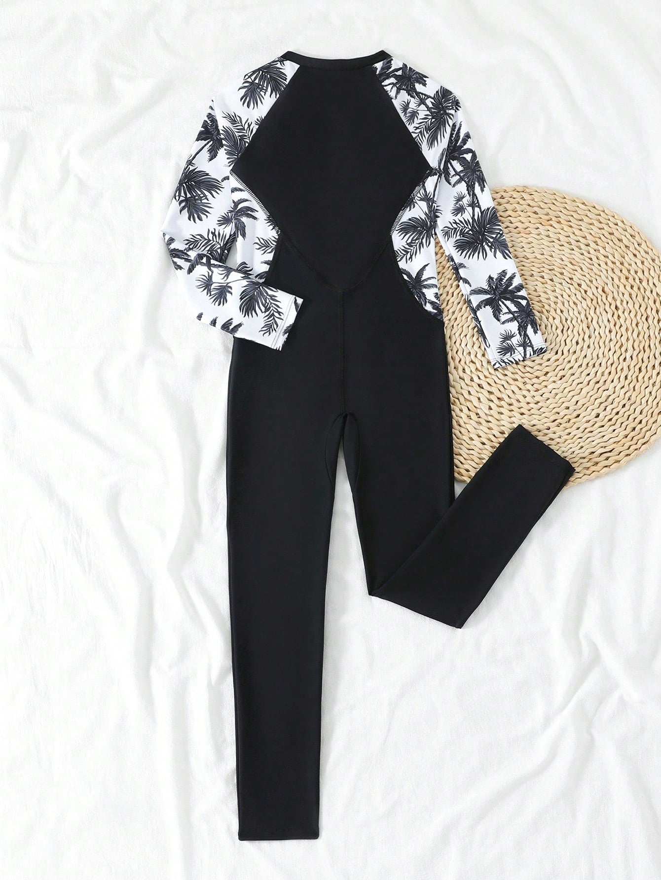 Tween girls black one-piece swimsuit with long sleeves, high neck, zipper detail, graphic leopard heart print, and fitted full-coverage swimwear style.