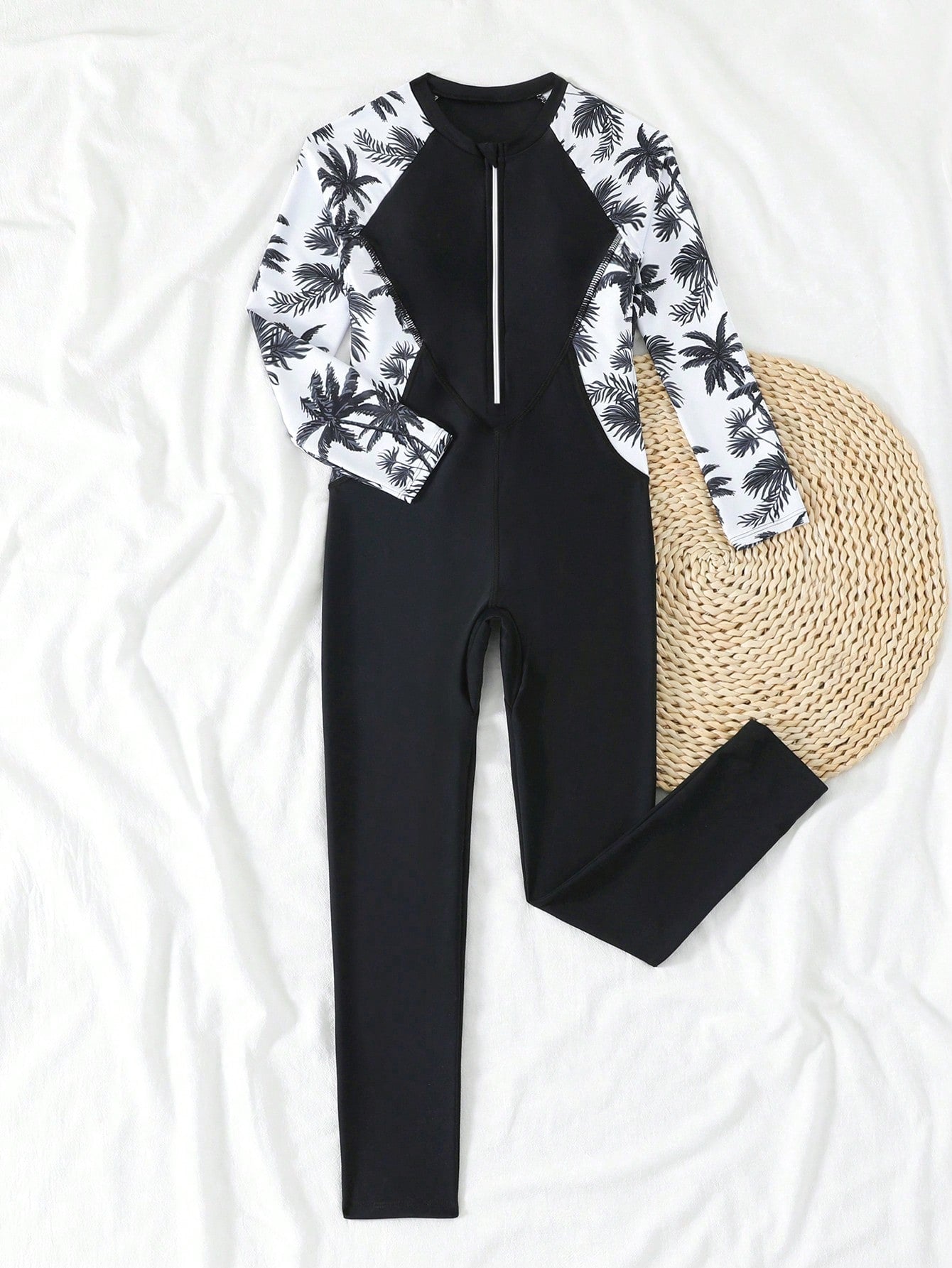 Tween girls black one-piece swimsuit with long sleeves, high neck, zipper detail, graphic leopard heart print, and fitted full-coverage swimwear style.