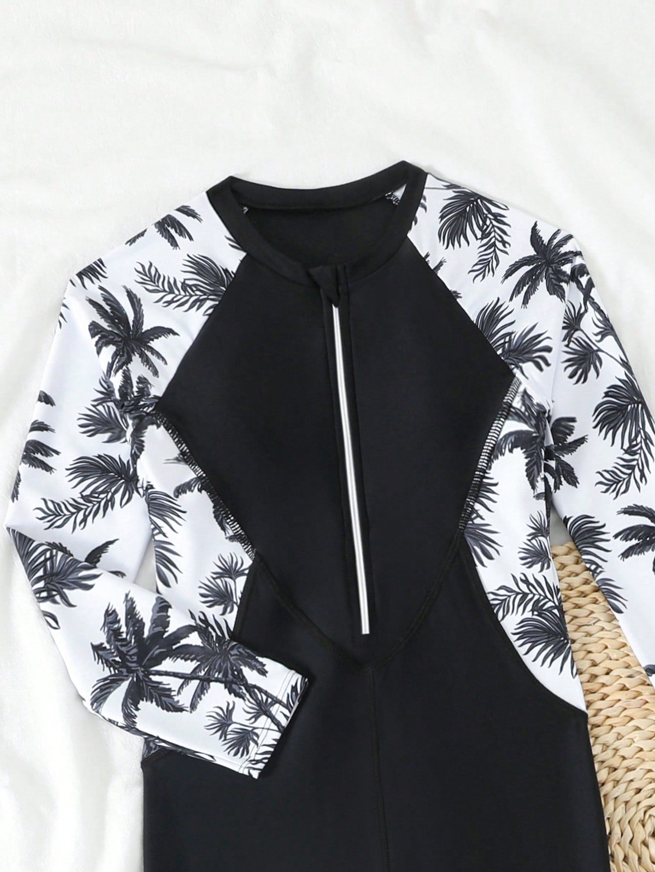 Tween girls black one-piece swimsuit with long sleeves, high neck, zipper detail, graphic leopard heart print, and fitted full-coverage swimwear style.