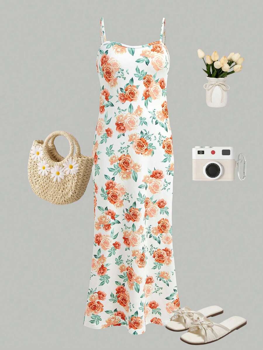 Tween girls black cami midi dress featuring plant print, spaghetti straps, slim fit, and a flared hem.