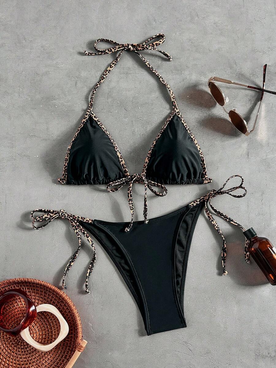 Women's tropical print two-piece halter bikini set featuring wireless triangle cups with tie-back detail and high-waist bikini bottoms.