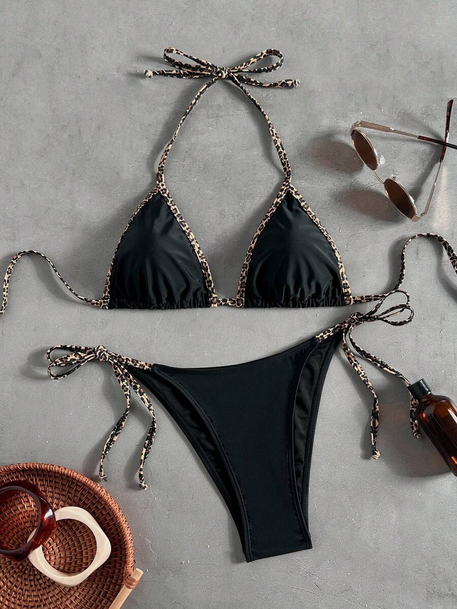 Women's tropical print two-piece halter bikini set featuring wireless triangle cups with tie-back detail and high-waist bikini bottoms.