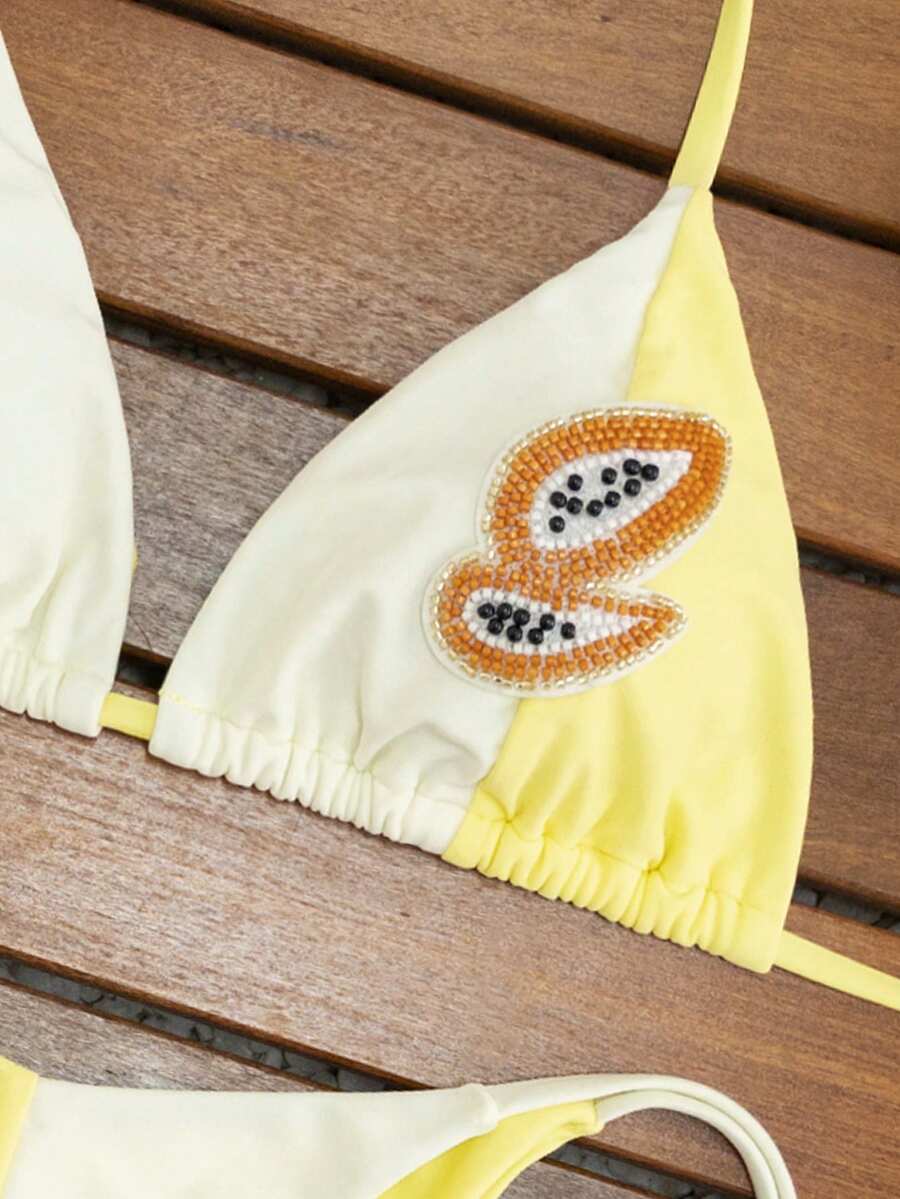 Women's triangle bikini set with contrast lace wireless bra top and ultra high waist tie side bottoms.