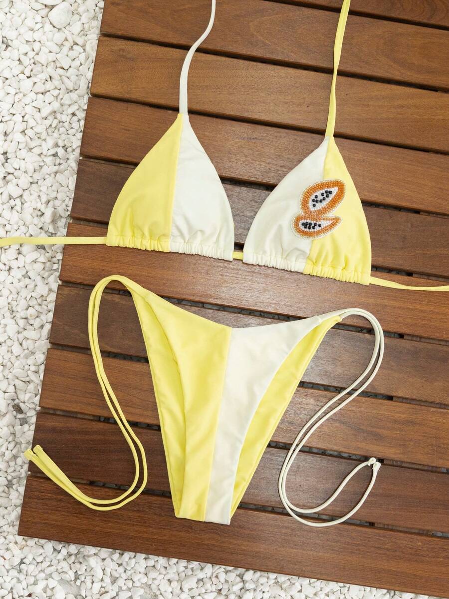 Women's triangle bikini set with contrast lace wireless bra top and ultra high waist tie side bottoms.