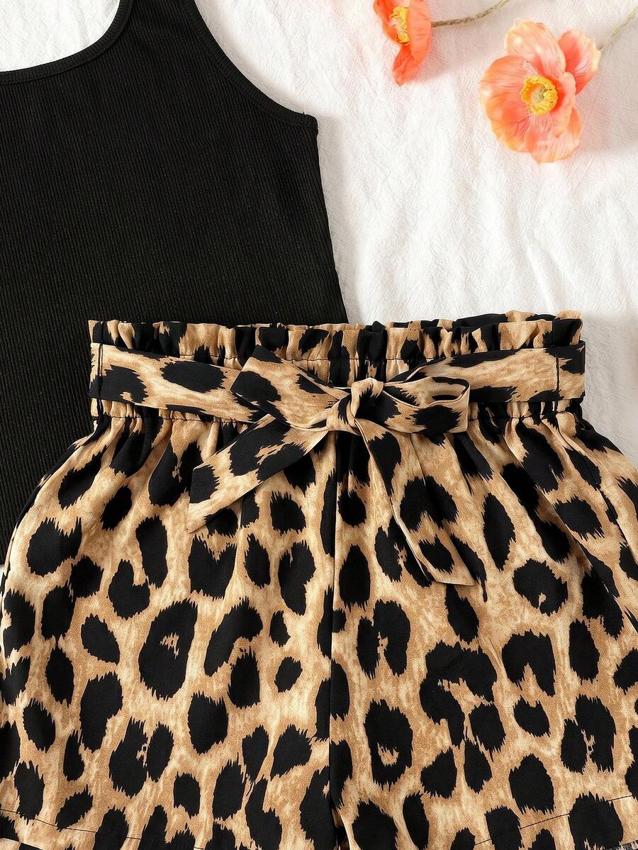 Tween girl wearing a casual 2-piece set featuring a black rib-knit scoop neck tank top and leopard print paperbag waist shorts with a matching belt.