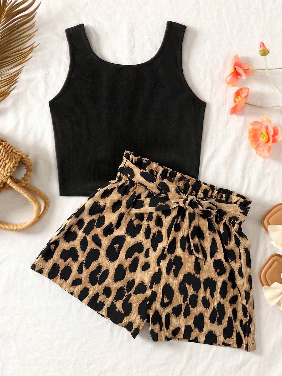 Tween girl wearing a casual 2-piece set featuring a black rib-knit scoop neck tank top and leopard print paperbag waist shorts with a matching belt.