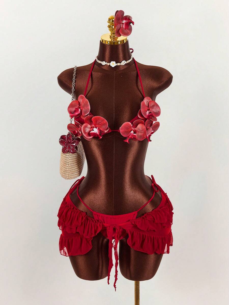 Women's 3-piece blue bikini swimwear set featuring a crop top with 3D rose accents, tie back detail, spaghetti straps, and tie-side bottoms.