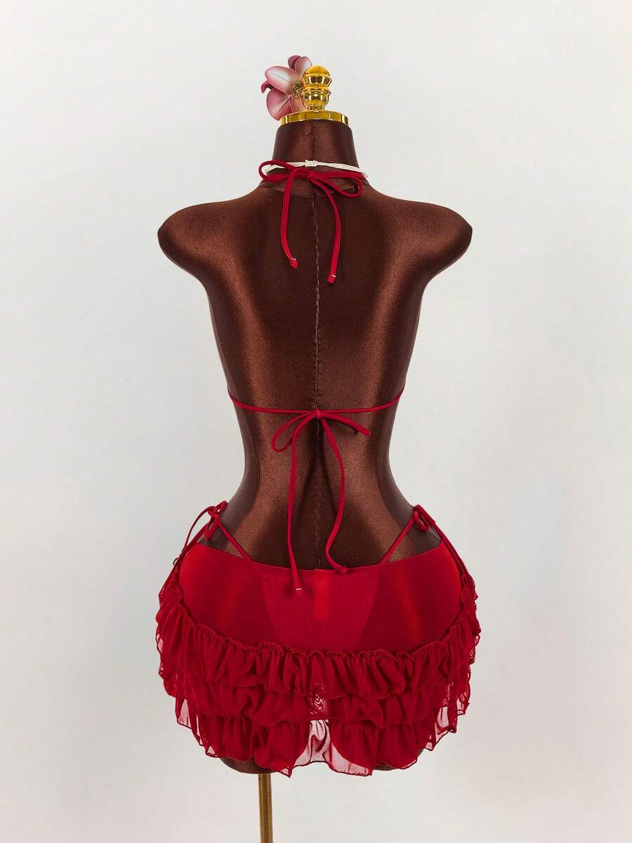 Women's 3-piece blue bikini swimwear set featuring a crop top with 3D rose accents, tie back detail, spaghetti straps, and tie-side bottoms.