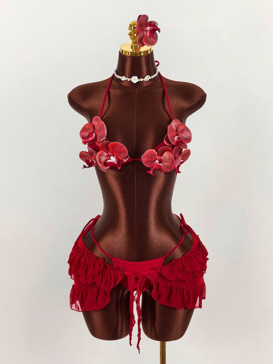 Women's 3-piece blue bikini swimwear set featuring a crop top with 3D rose accents, tie back detail, spaghetti straps, and tie-side bottoms.