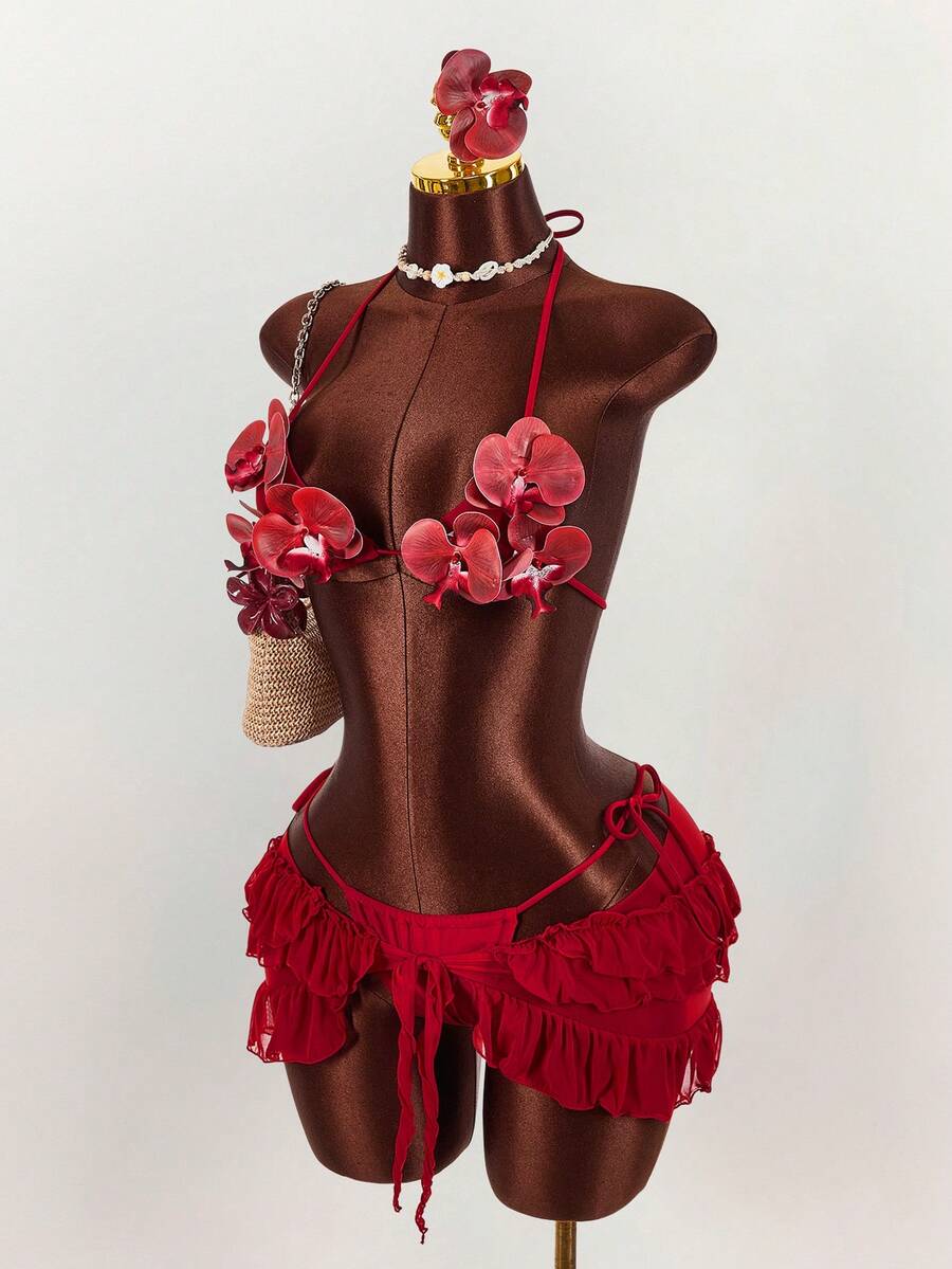 Women's 3-piece blue bikini swimwear set featuring a crop top with 3D rose accents, tie back detail, spaghetti straps, and tie-side bottoms.