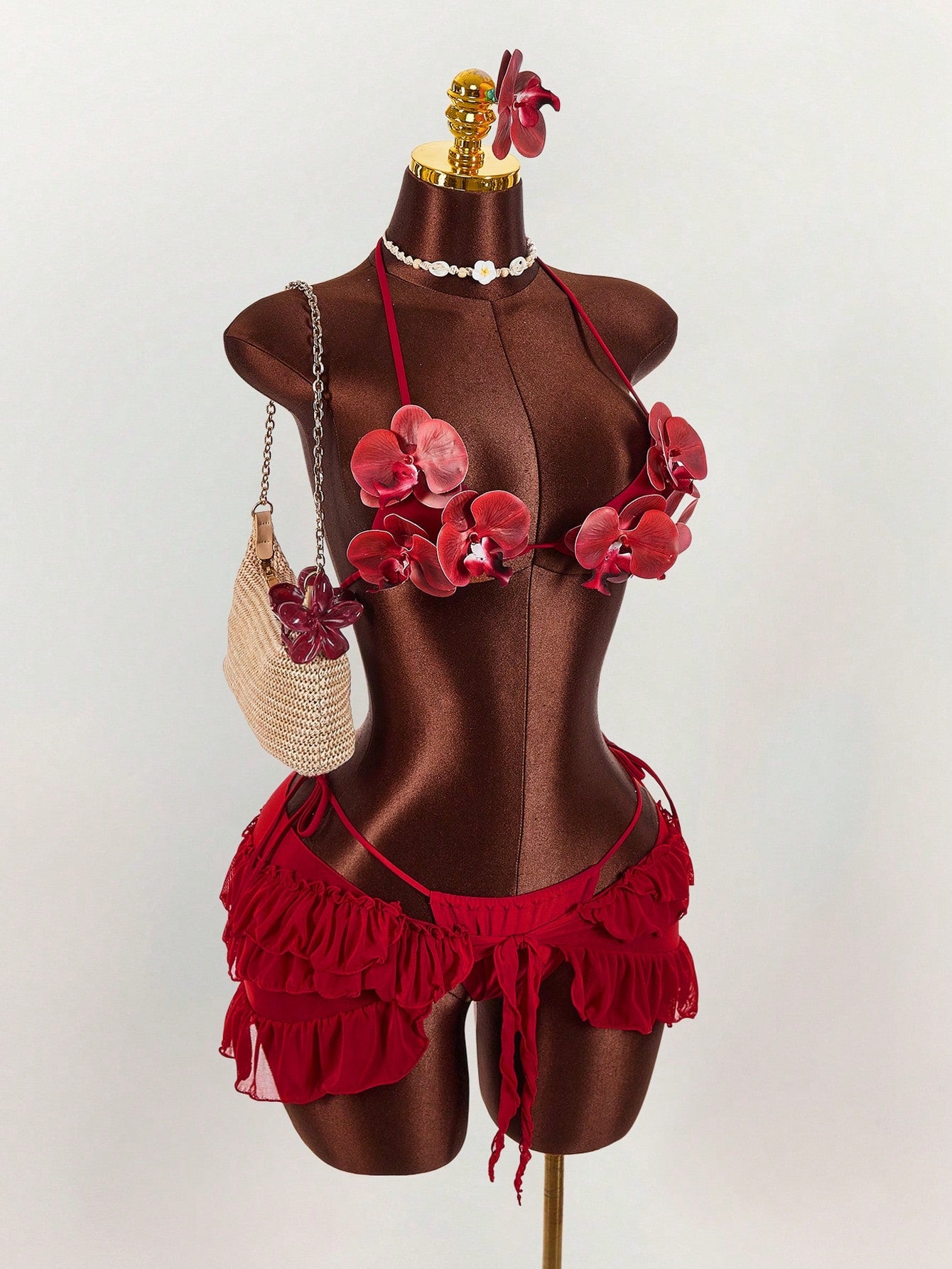 Women's 3-piece blue bikini swimwear set featuring a crop top with 3D rose accents, tie back detail, spaghetti straps, and tie-side bottoms.