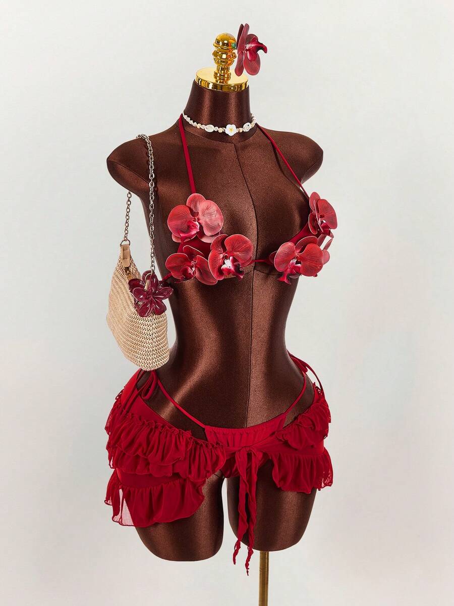 Women's 3-piece blue bikini swimwear set featuring a crop top with 3D rose accents, tie back detail, spaghetti straps, and tie-side bottoms.