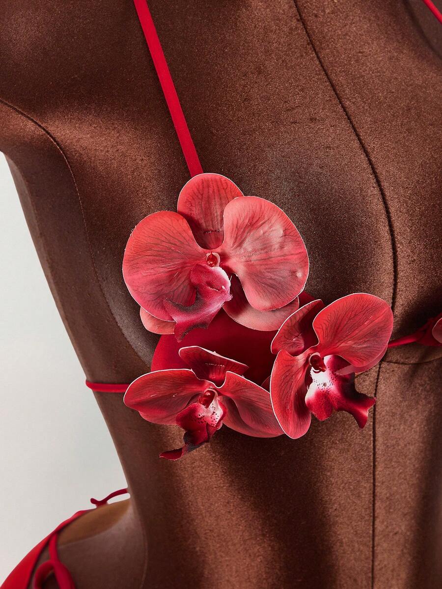 Women's 3-piece blue bikini swimwear set featuring a crop top with 3D rose accents, tie back detail, spaghetti straps, and tie-side bottoms.