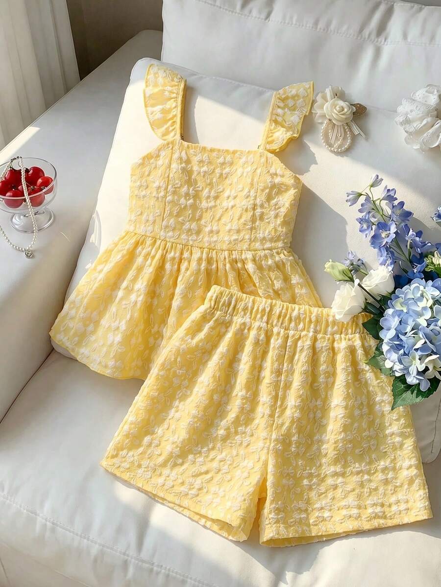 Tween girl wearing a blue and white striped sleeveless top featuring embroidery details and ruffle trim with matching shorts.