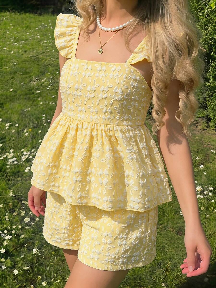 Tween girl wearing a blue and white striped sleeveless top featuring embroidery details and ruffle trim with matching shorts.