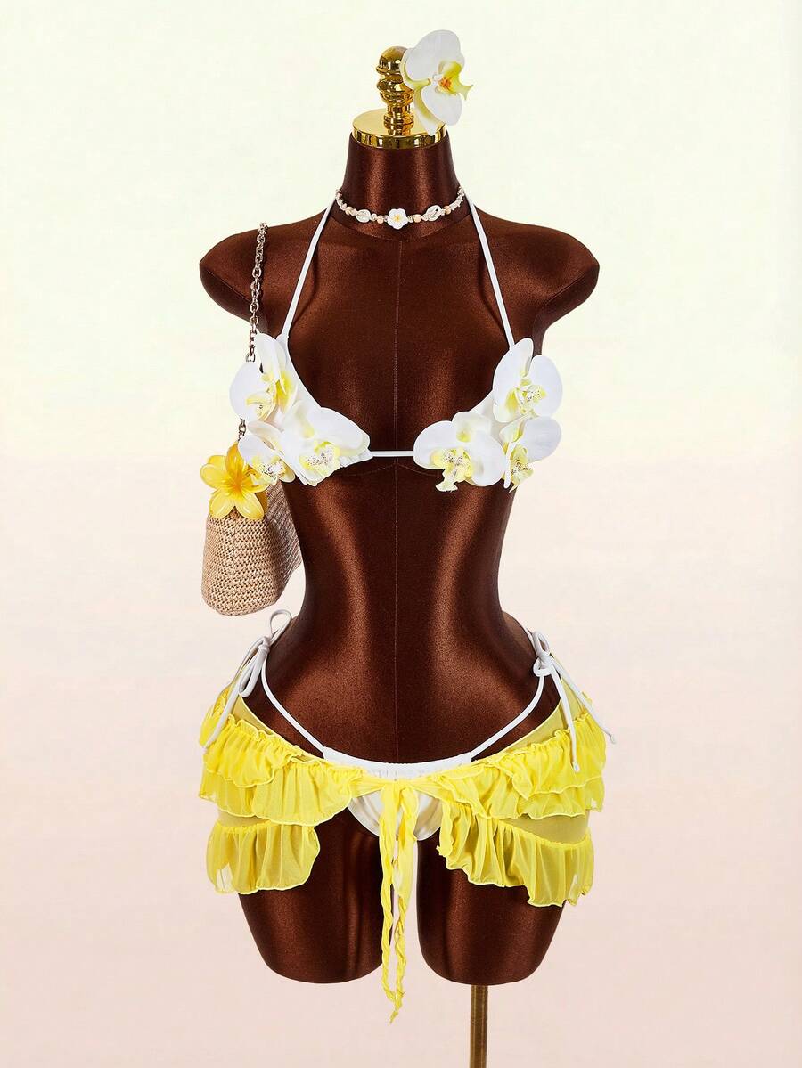 Women's 3-piece blue bikini swimwear set featuring a crop top with 3D rose accents, tie back detail, spaghetti straps, and tie-side bottoms.