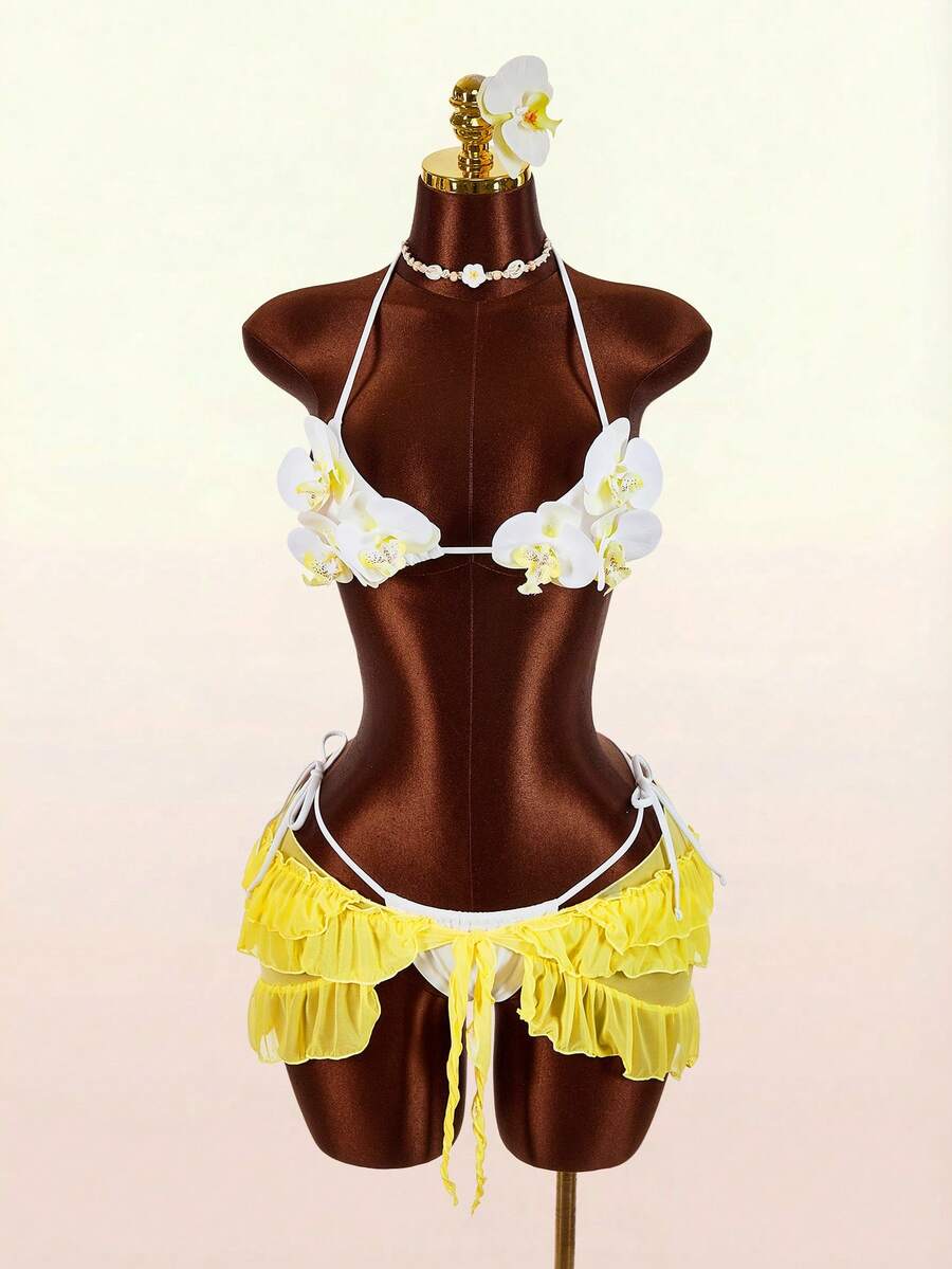 Women's 3-piece blue bikini swimwear set featuring a crop top with 3D rose accents, tie back detail, spaghetti straps, and tie-side bottoms.