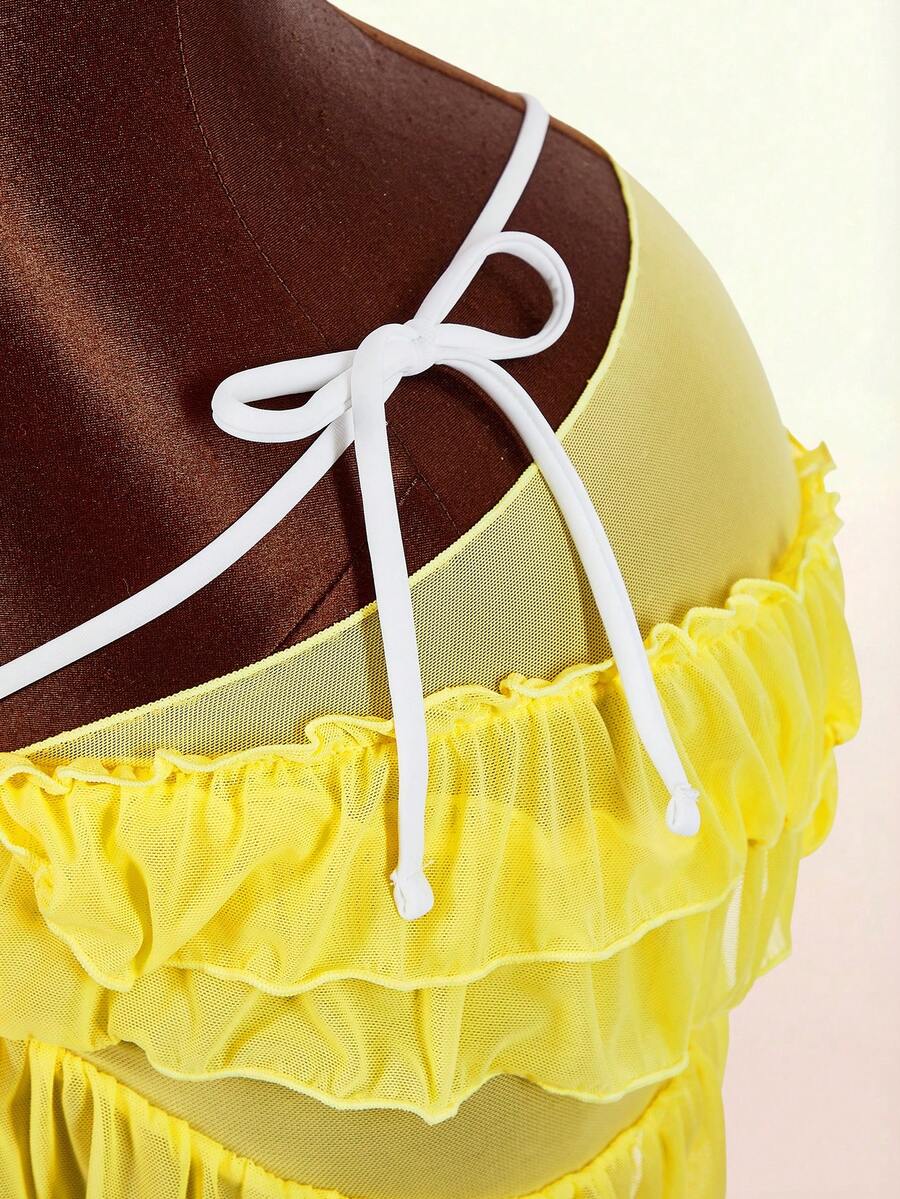 Women's 3-piece blue bikini swimwear set featuring a crop top with 3D rose accents, tie back detail, spaghetti straps, and tie-side bottoms.