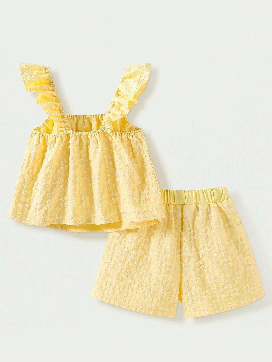 Tween girl wearing a blue and white striped sleeveless top featuring embroidery details and ruffle trim with matching shorts.
