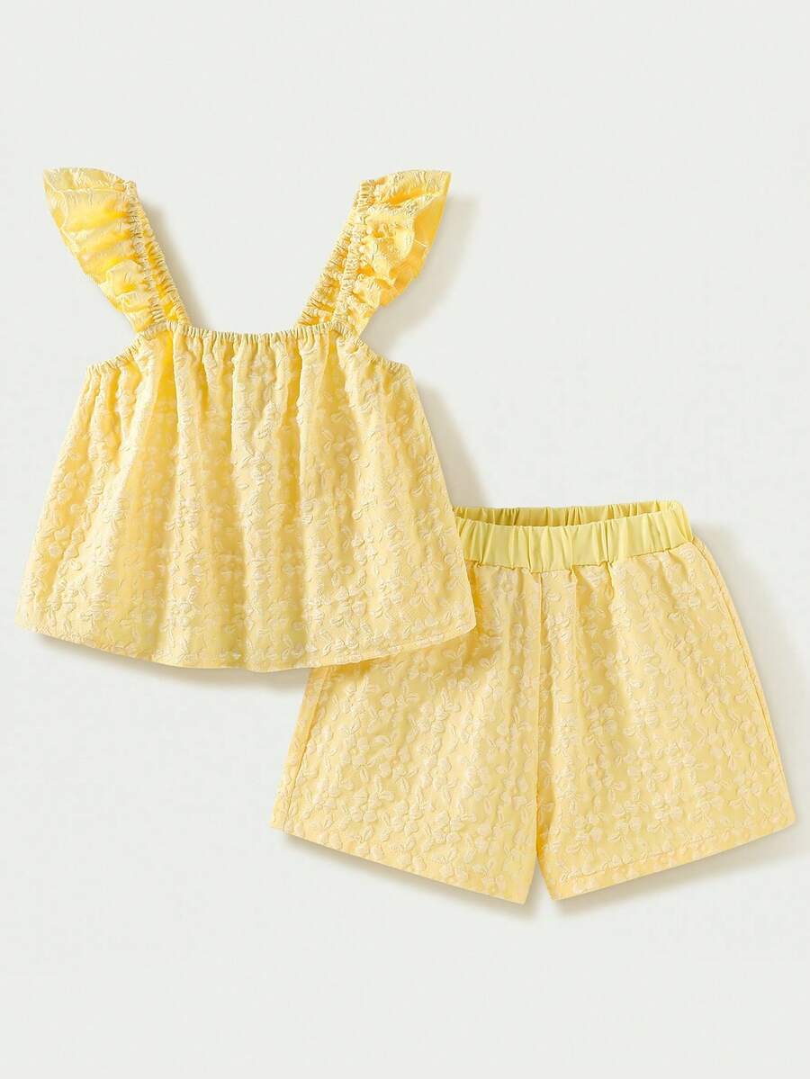 Tween girl wearing a blue and white striped sleeveless top featuring embroidery details and ruffle trim with matching shorts.