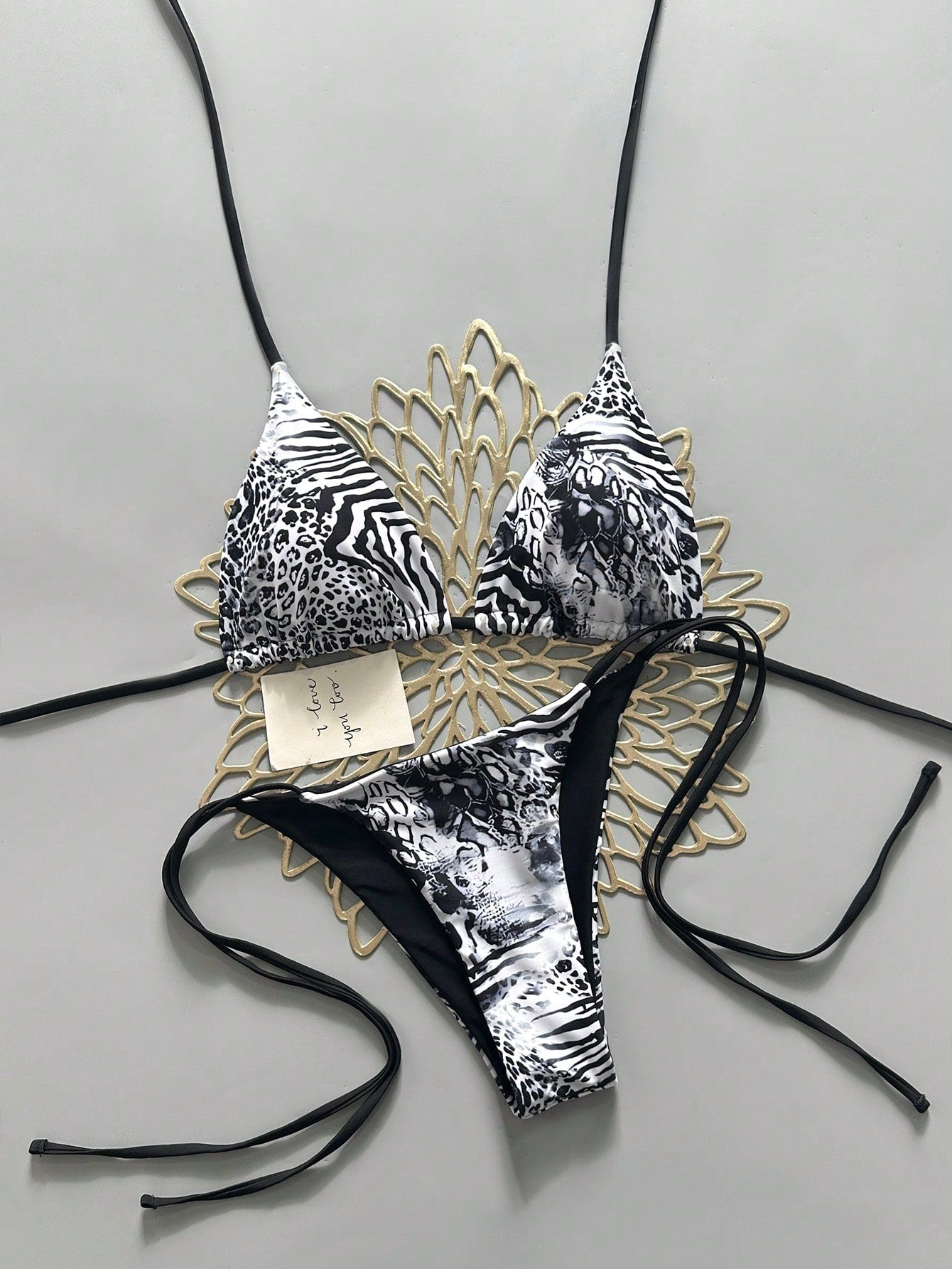Women's vintage leopard print 2-piece bikini set featuring a high waist tie-side bottom and a halter neck triangle top.