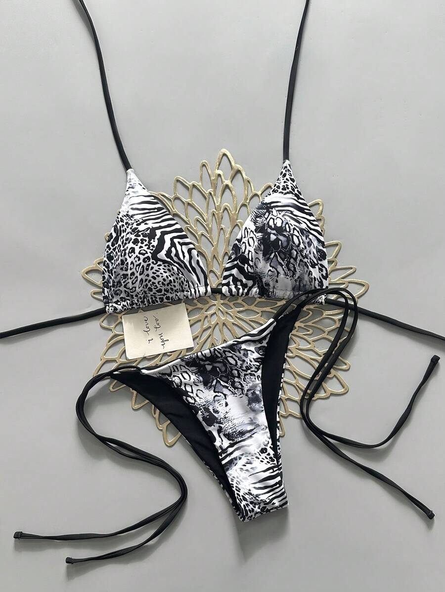 Women's vintage leopard print 2-piece bikini set featuring a high waist tie-side bottom and a halter neck triangle top.