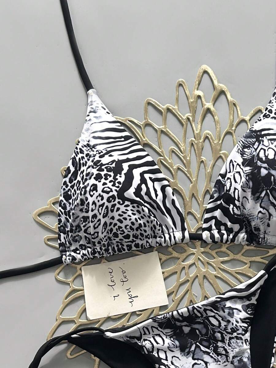 Women's vintage leopard print 2-piece bikini set featuring a high waist tie-side bottom and a halter neck triangle top.
