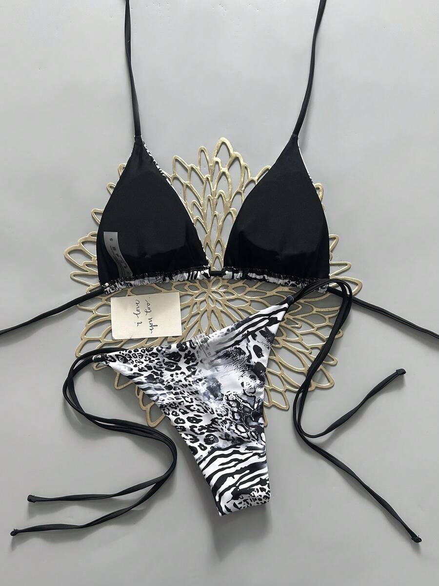 Women's vintage leopard print 2-piece bikini set featuring a high waist tie-side bottom and a halter neck triangle top.