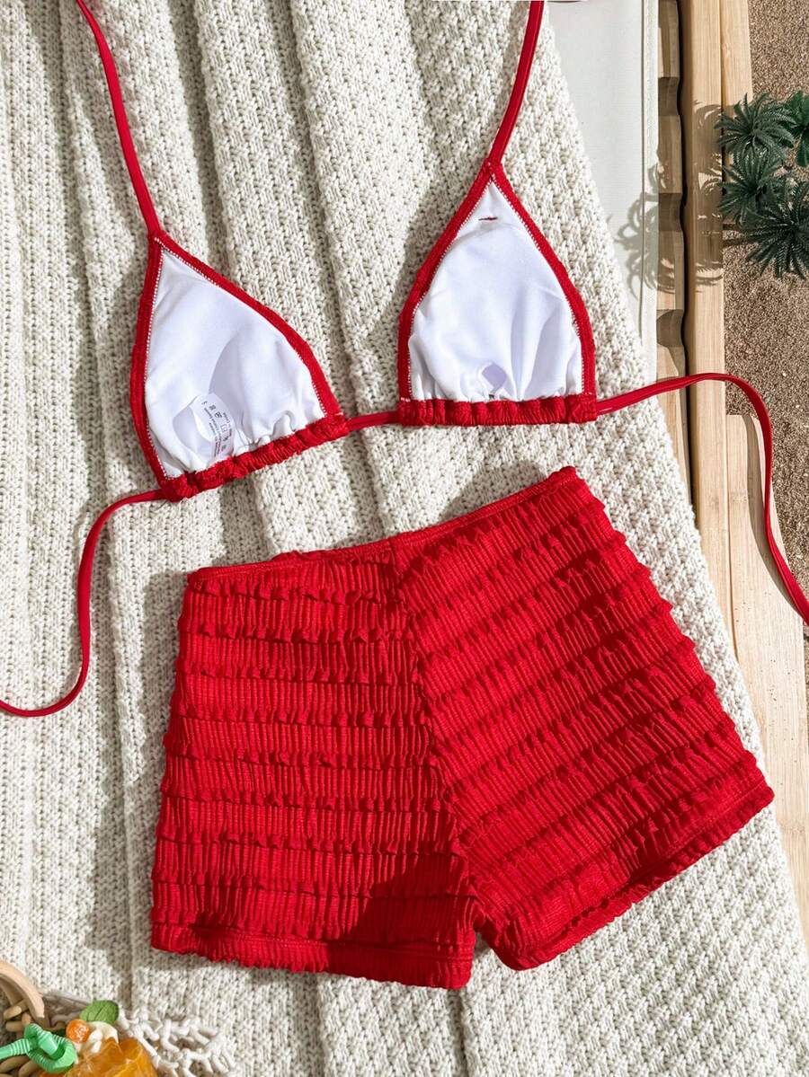 Women's apricot two-piece swimsuit set with a halter tie-back top and matching high stretch shorts.