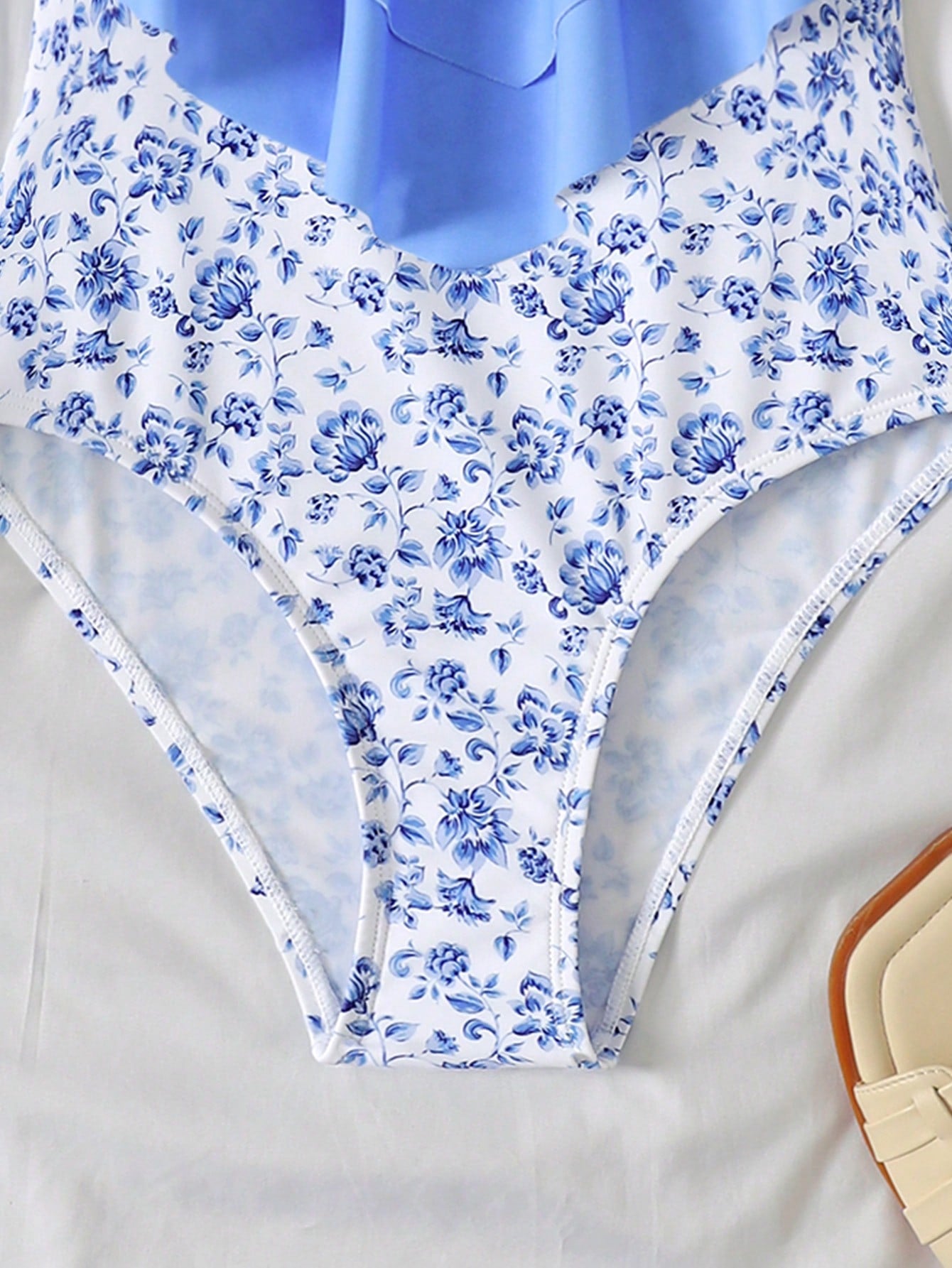 NEWSHEIN tween girls fitted one-piece swimsuit in blue and white plant pattern with ruffle tiered detail, spaghetti straps, and lined body for beach or resort wear