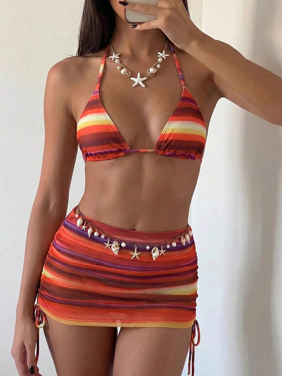 Women's black 3-piece bikini set featuring a halter triangle top with removable padding, high-waisted bottoms, and a knee-length mesh skirt with tie details.