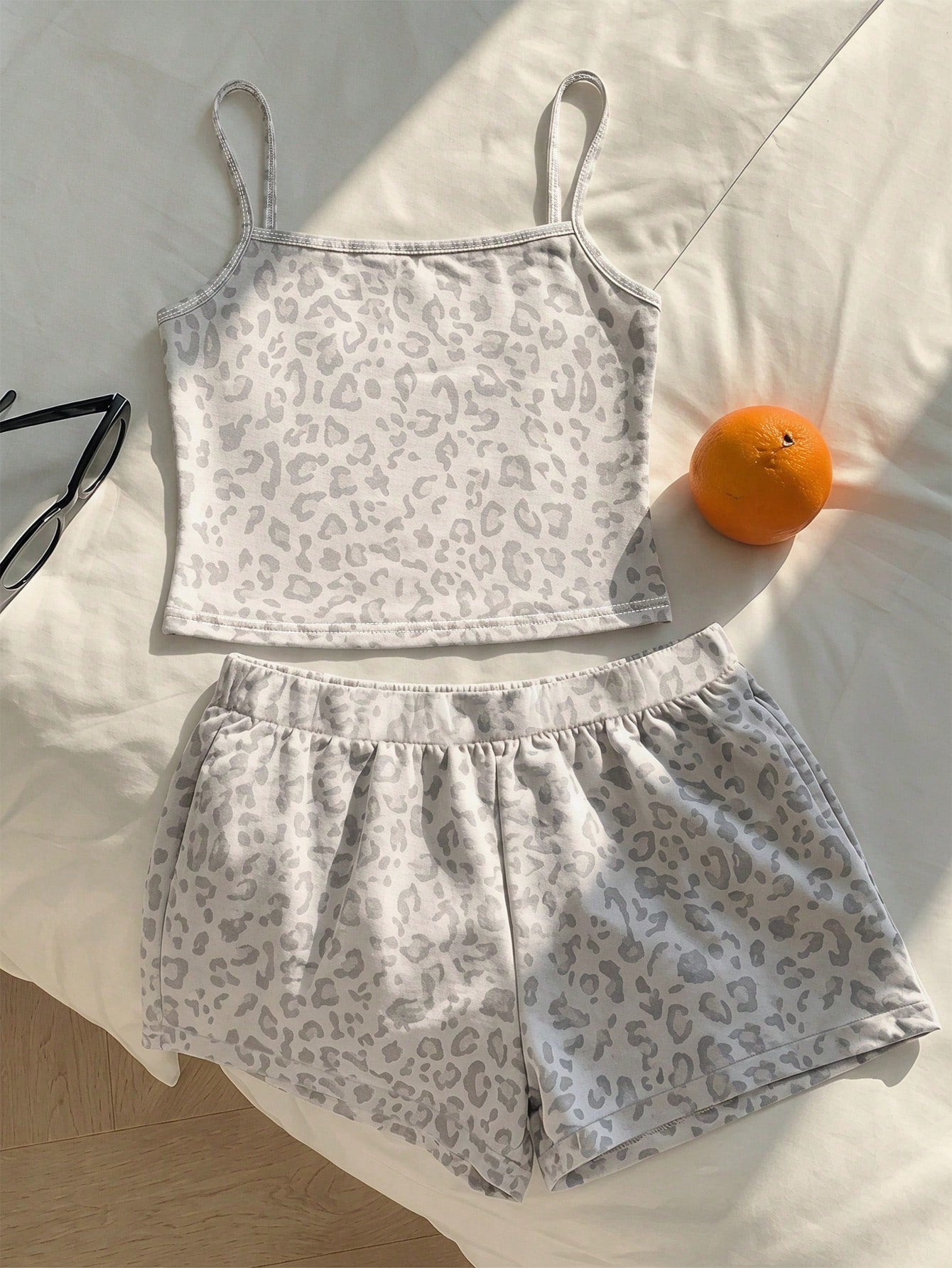 Tween girls summer 2-piece Hawaiian style outfit featuring a graphic print spaghetti strap camisole top with contrast piping and matching casual shorts.