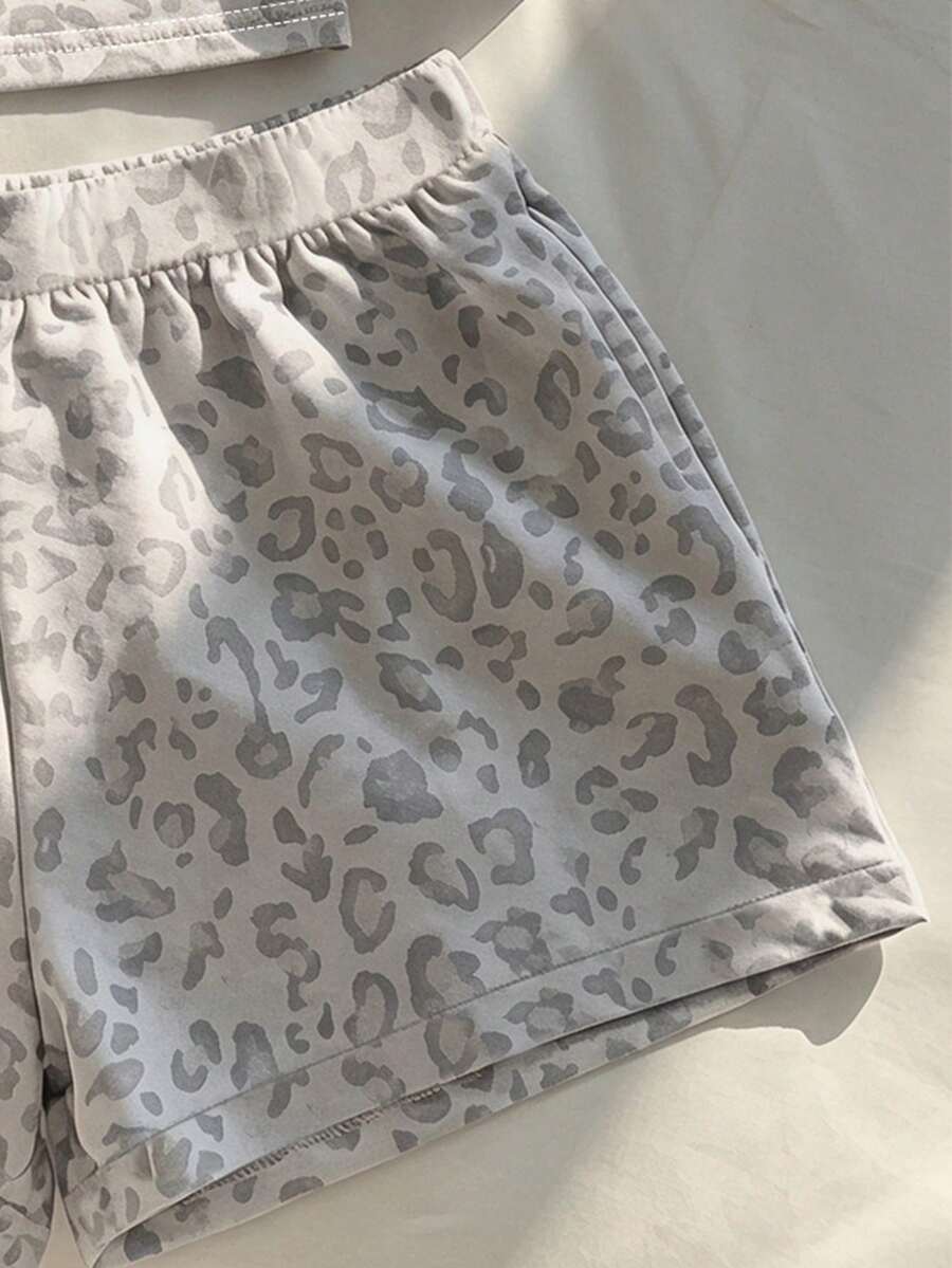Tween girls summer 2-piece Hawaiian style outfit featuring a graphic print spaghetti strap camisole top with contrast piping and matching casual shorts.