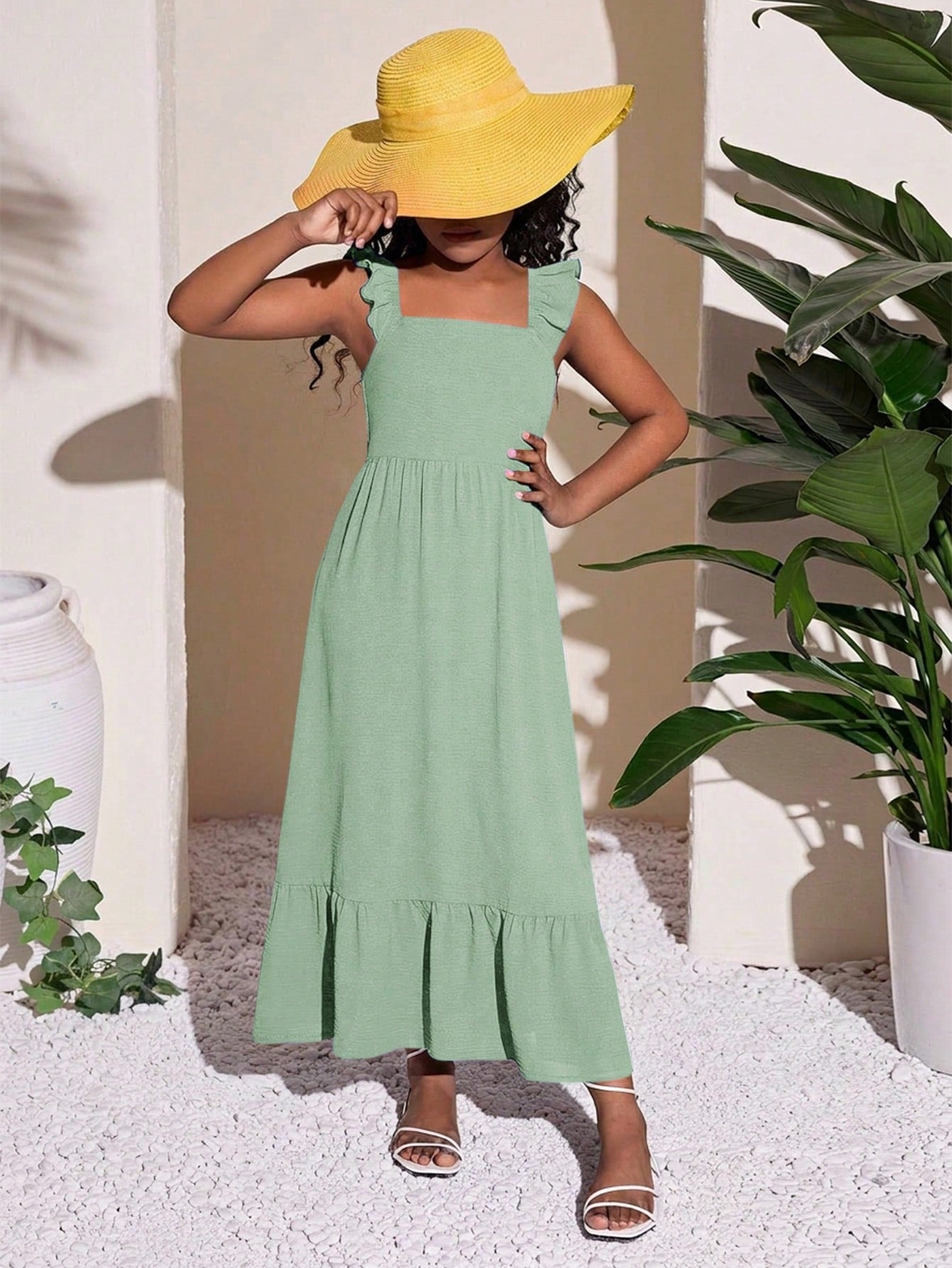 Tween girls A-line vacation dress with square neck, shirred cinched waist, ruffle details, zipper closure, and flounce hem.