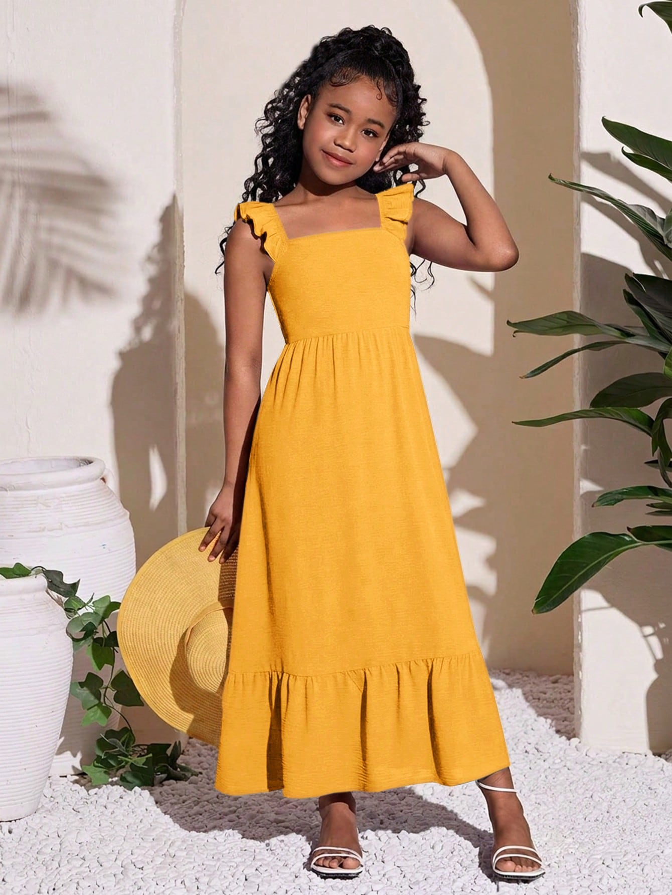 Tween girls A-line vacation dress with square neck, shirred cinched waist, ruffle details, zipper closure, and flounce hem.