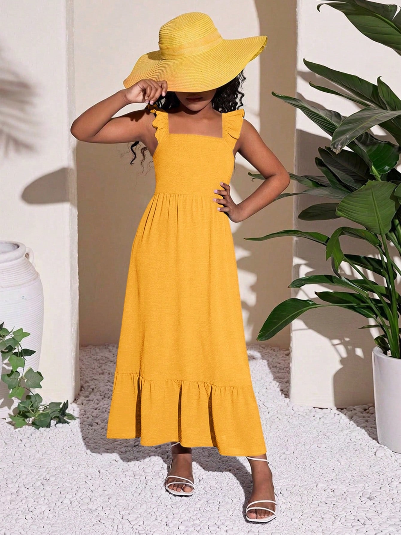 Tween girls A-line vacation dress with square neck, shirred cinched waist, ruffle details, zipper closure, and flounce hem.