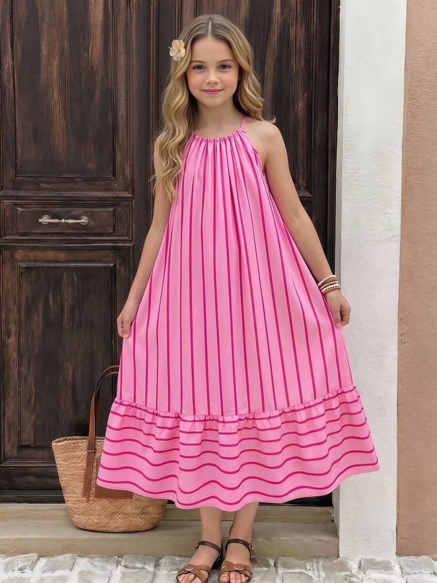 Tween girls green floral print cami dress with halter neckline, sleeveless cut, zipper detail, flared hem, and long vacation style silhouette.