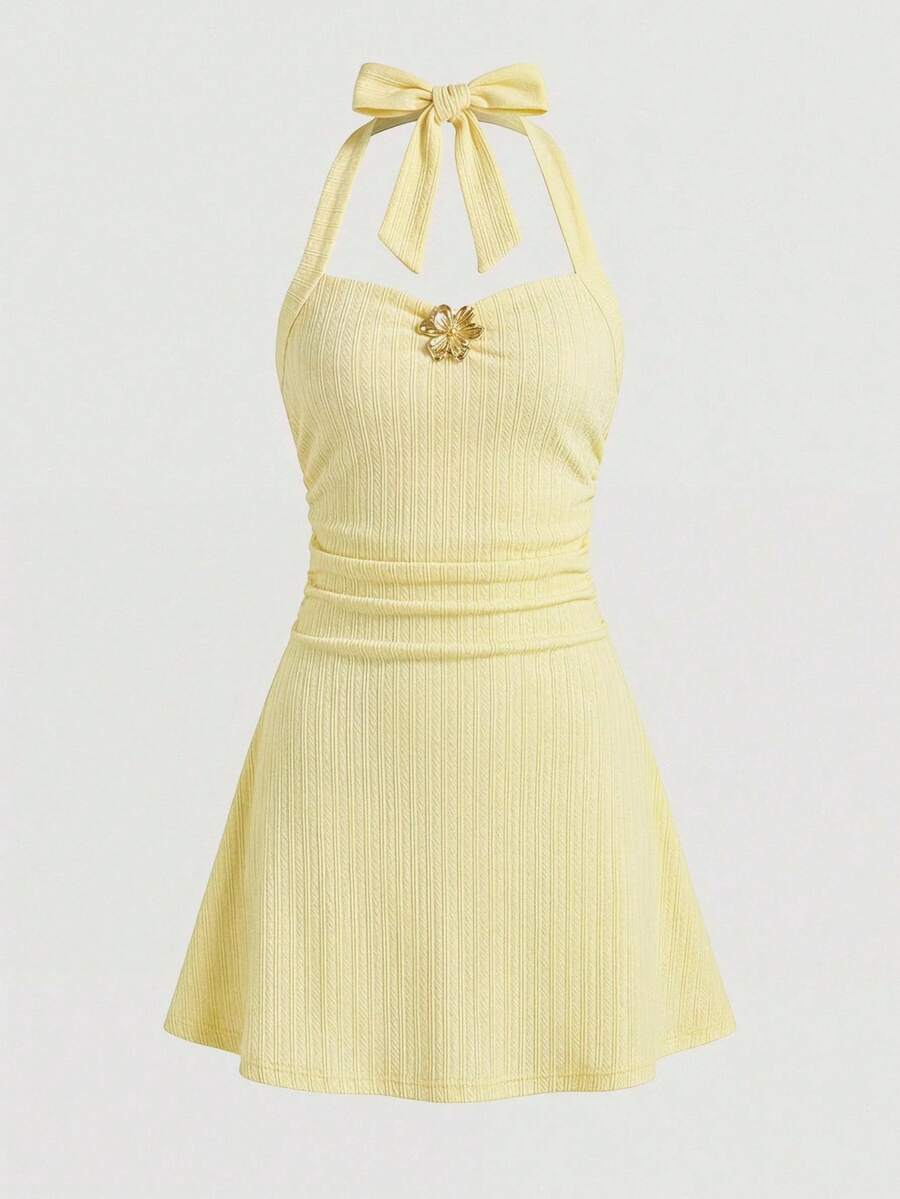 Apricot tween girls sleeveless halter cami dress with appliques, bow front, zipper detail, high waist, flared hem, and short slim fit design.