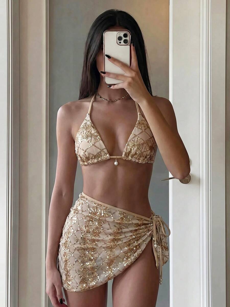 Women's 3-piece blue tropical shell print bikini set featuring a halter bralette top, low-waist tie-side bottom, and a matching sheer mesh cover-up skirt.