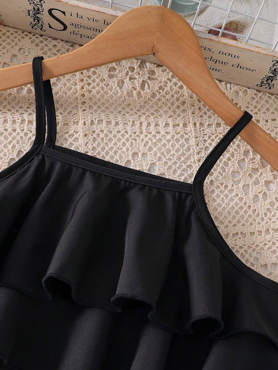 Tween girls blue 2-piece vacation outfit set featuring a tiered ruffle spaghetti strap camisole and loose high-waist pants.