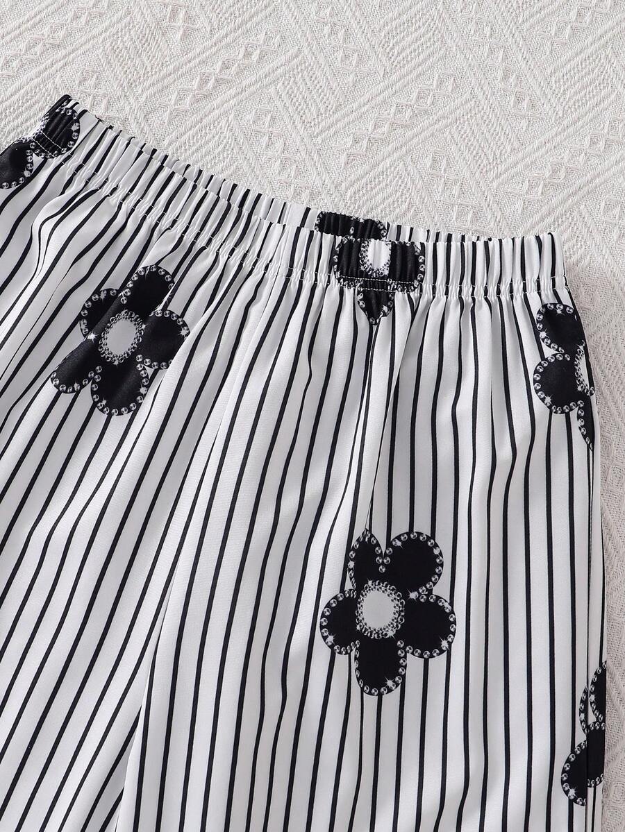 Tween girls blue 2-piece vacation outfit set featuring a tiered ruffle spaghetti strap camisole and loose high-waist pants.