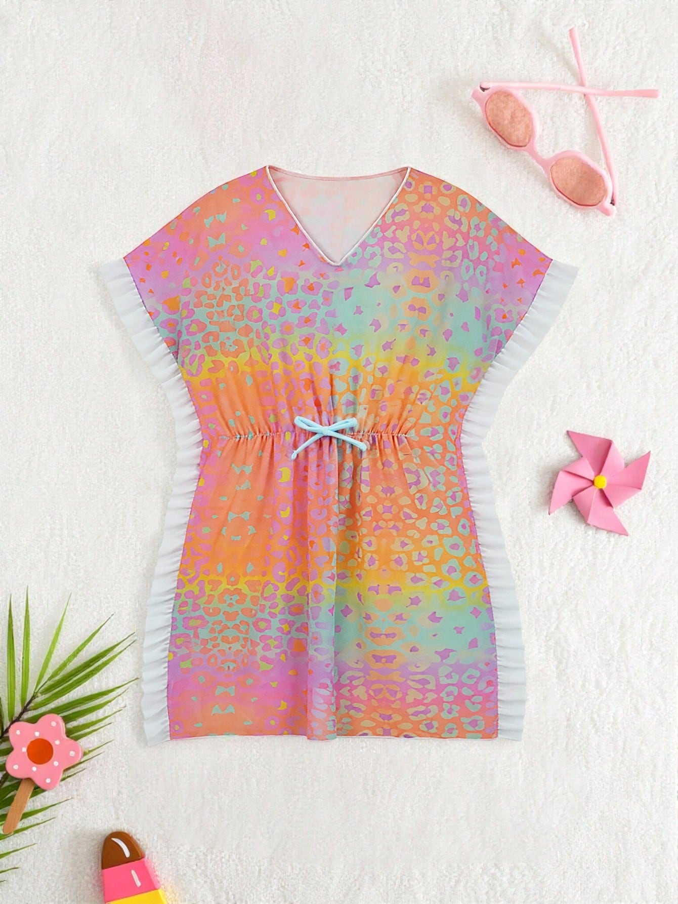 Blue tween girls swimsuit cover up with geometric starfish print, ruffle trim, round neck, short sleeves, and semi-sheer knit fabric for beach or pool wear.