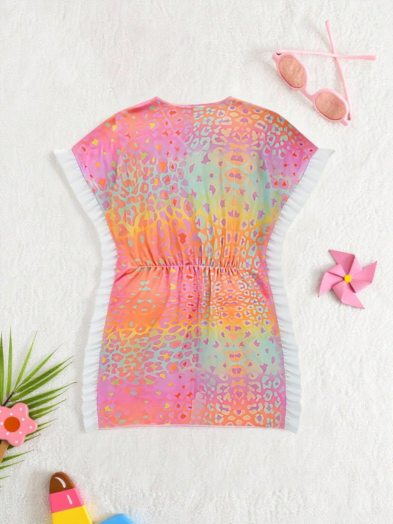 Blue tween girls swimsuit cover up with geometric starfish print, ruffle trim, round neck, short sleeves, and semi-sheer knit fabric for beach or pool wear.