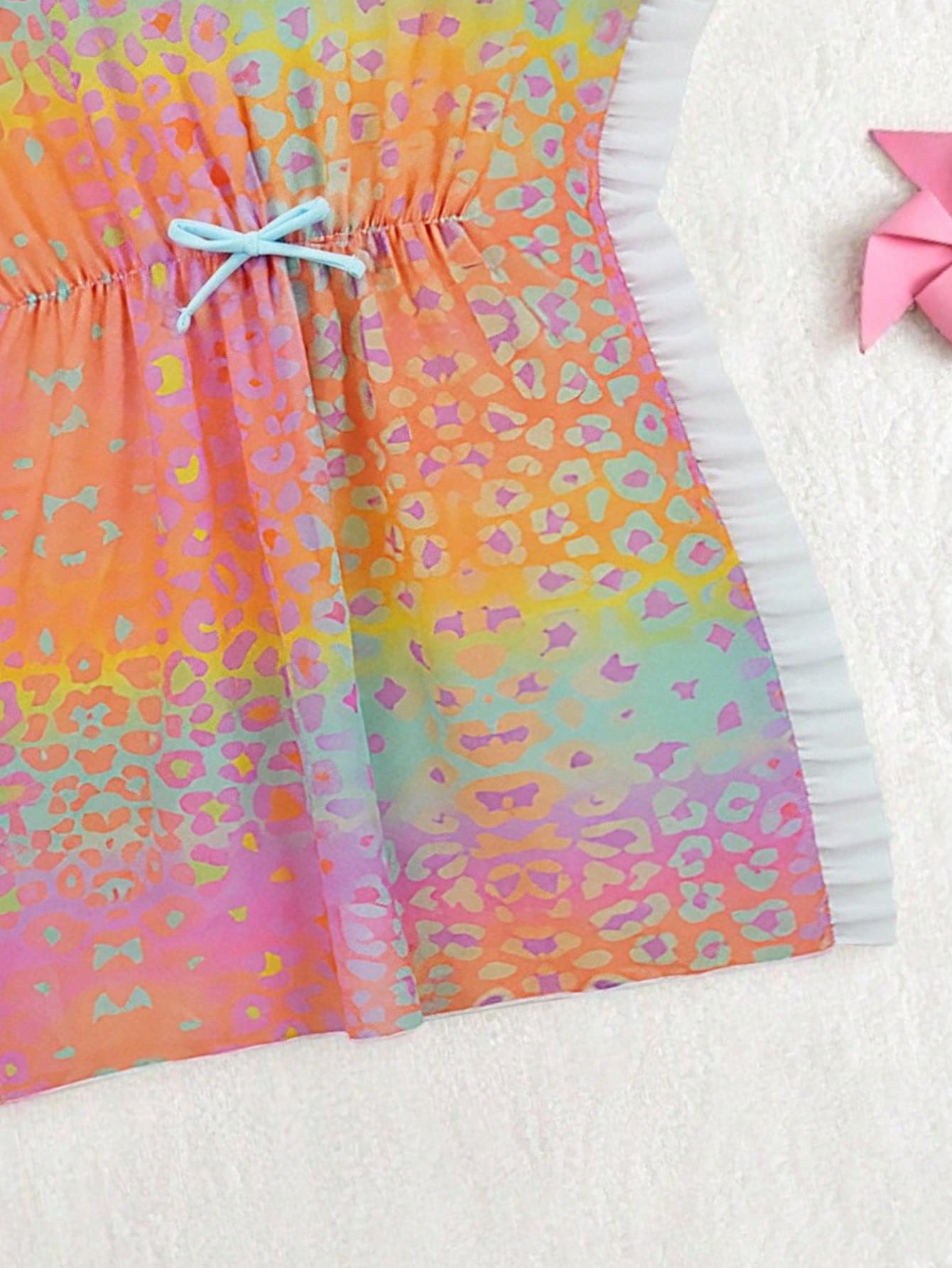 Blue tween girls swimsuit cover up with geometric starfish print, ruffle trim, round neck, short sleeves, and semi-sheer knit fabric for beach or pool wear.